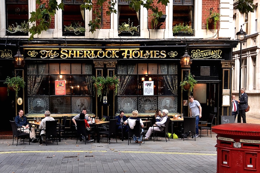 Traditional London pub with outdoor seating and red post box