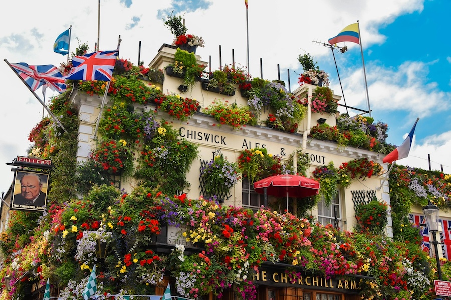 Traditional English pub exterior with floral display in London